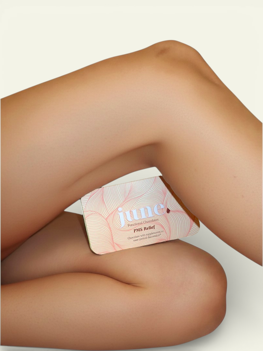 Woman resting with June PMS Relief chocolate for menstrual comfort