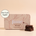 June PMS Relief functional chocolate tin for cramps and bloating on a soft background