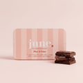 June Flow & Glow daily hormone support chocolate tin on a soft background